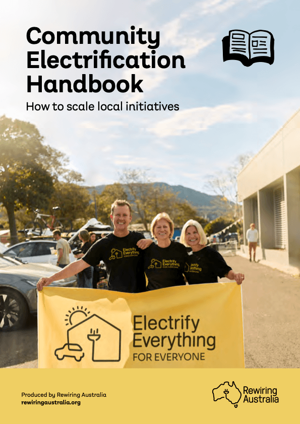Photo of a report cover with the words 'Community Electrification Handbook'. In the photo, three people are smiling directly at the camera, holding a posted that says 'Electrify everything for everyone'.
