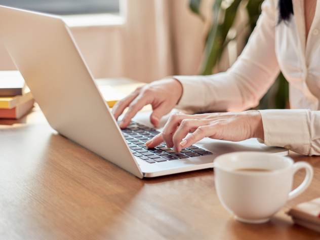 Woman typing on a laptop