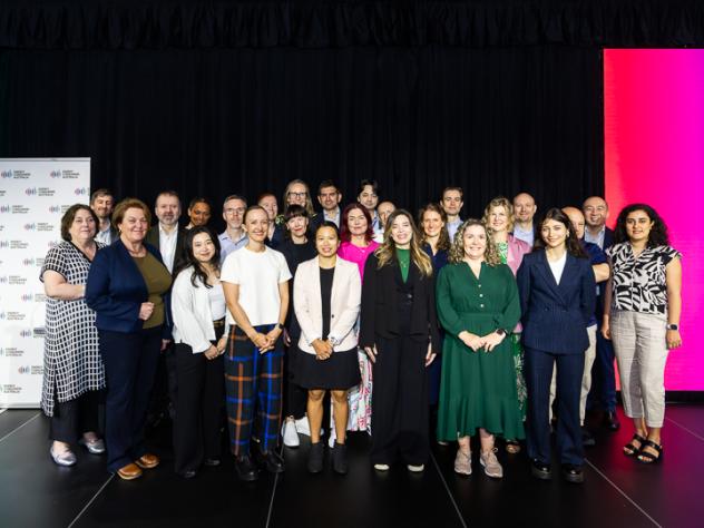 Photo of the ECA team at Foresighting Forum 2026. The team is standing on stage in front of a black curtain, smiling.