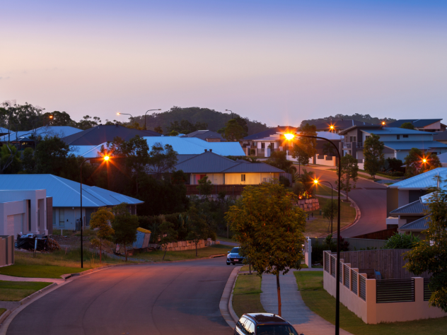 Photo of Australian neighbourhood at dusk; illuminated by purple blue light and street lights