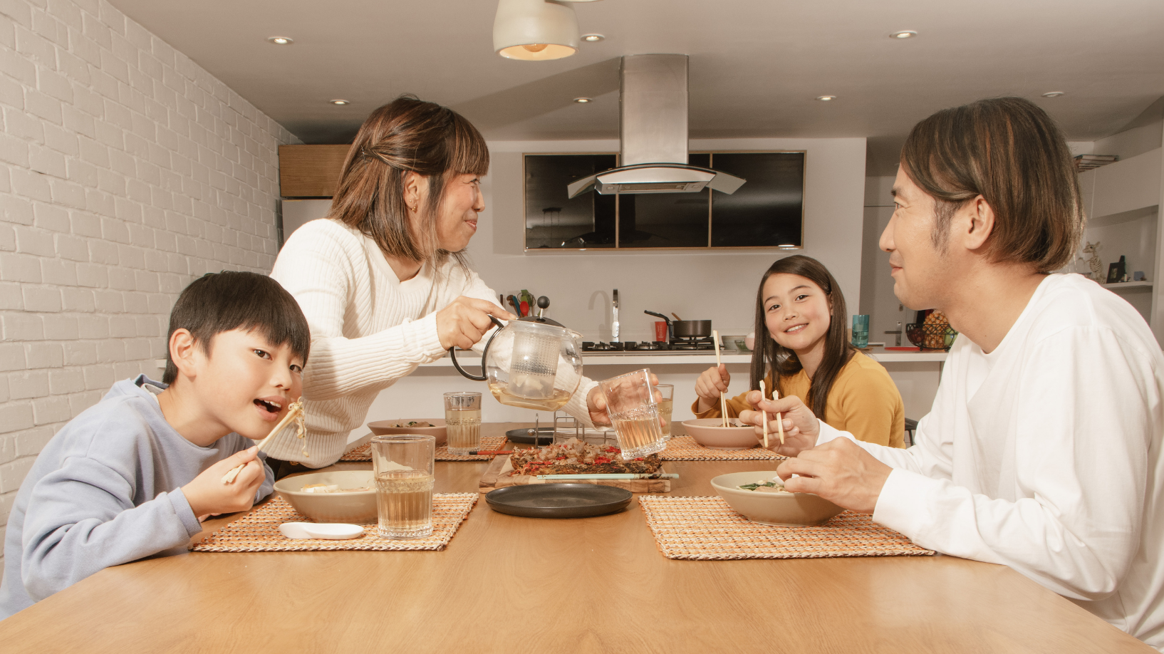 Family sitting at a table eating.