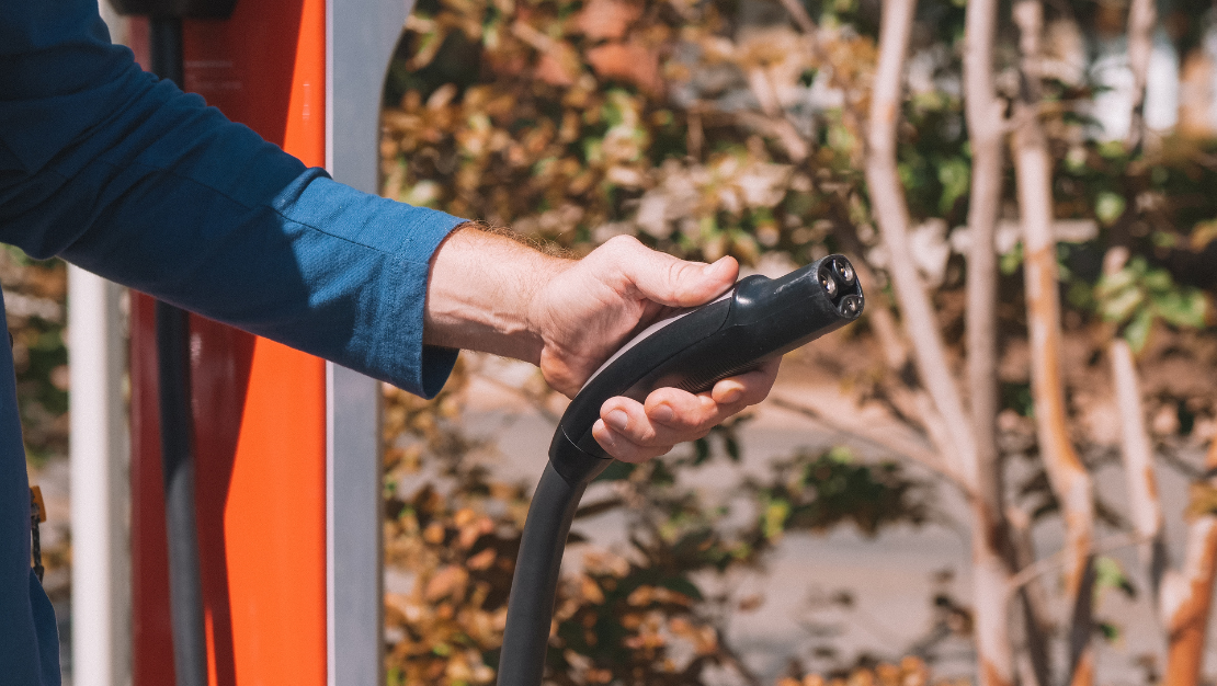 Photo of a hand holding an EV charging cable