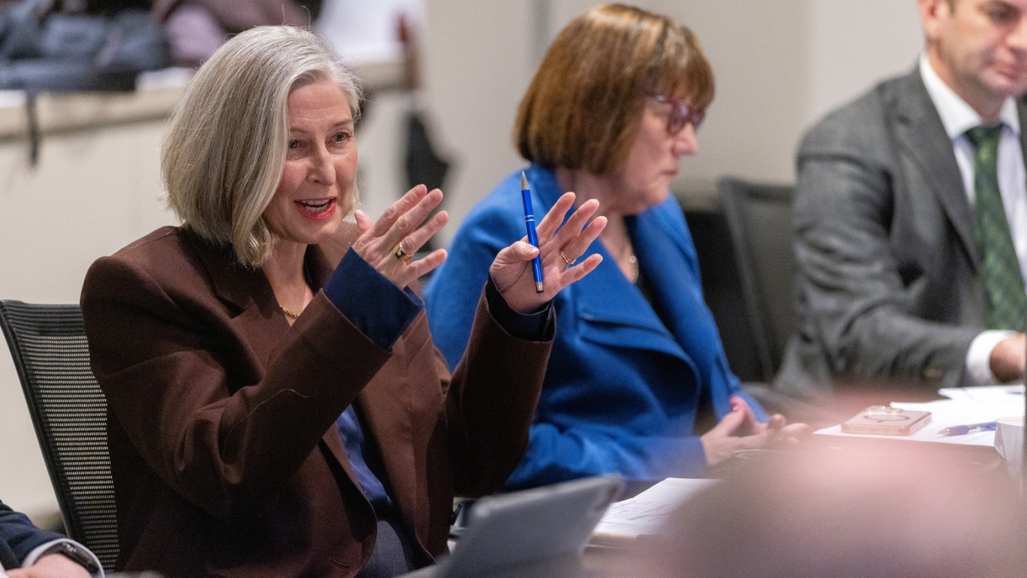 Photo of a person speaking while gesticulating with their hands