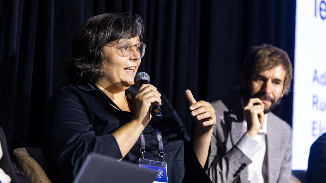 Photo of Erin Turner from Consumer Policy Research Centre, speaking into a microphone on a stage.
