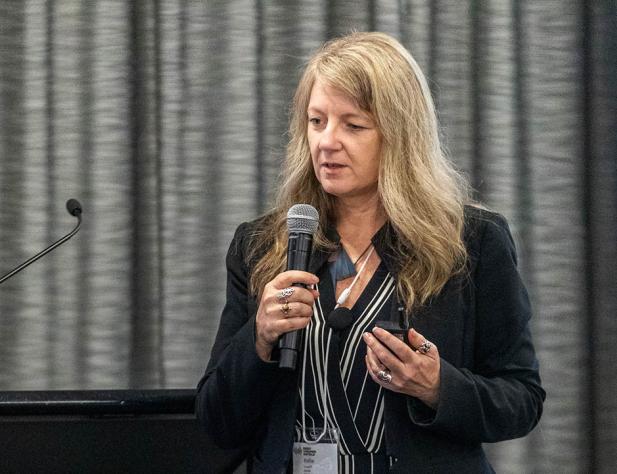 Blonde woman speaking into microphone