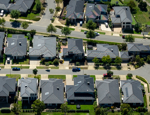 Aerial photo of lots of houses with grey rooftops