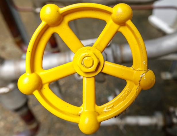 Close-up photo of a gas valve painted yellow