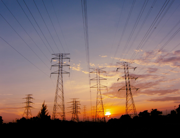Photo of transmission towers at sunset