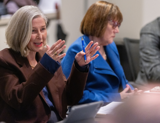 Photo of a person speaking while gesticulating with their hands