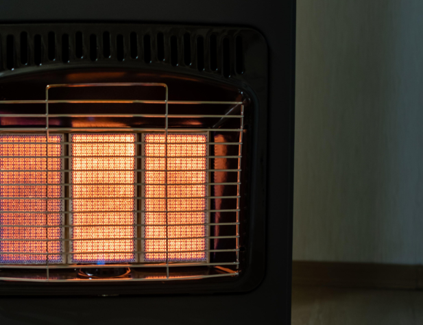 Close-up photo of a gas heater in a dark room
