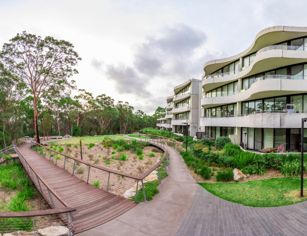 Photo of Australian apartment block, with pathway leading to bushland