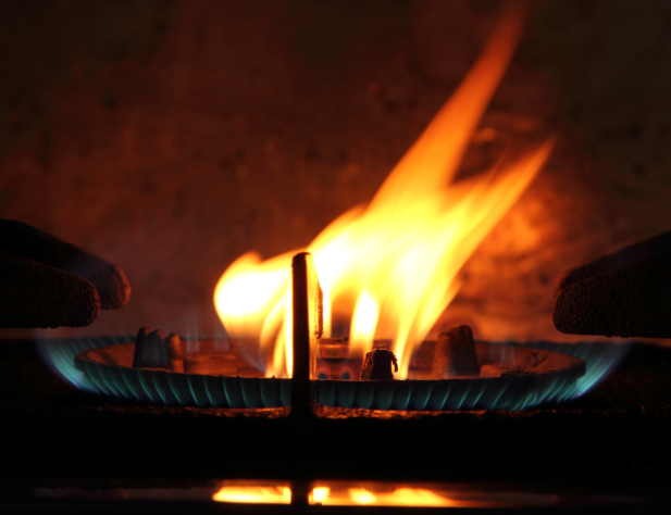 Close-up photo of a gas burner with an orange flame