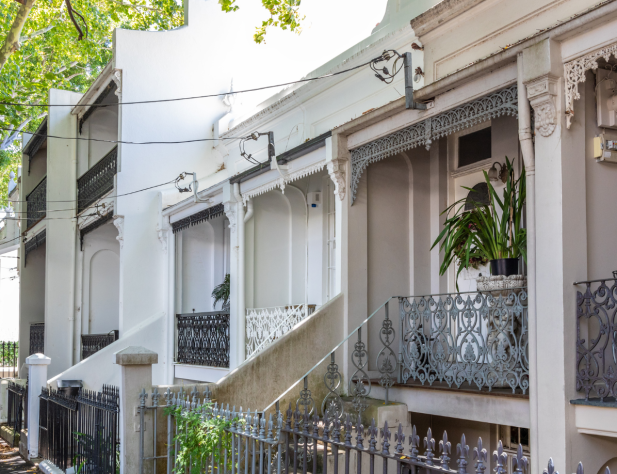 Photo of terrace houses in Sydney, Australia connecting to mains power via a power line.