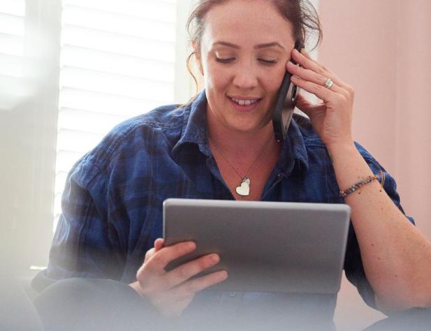 Photo of person on phone looking at bill