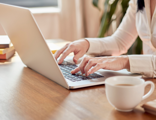 Woman typing on a laptop