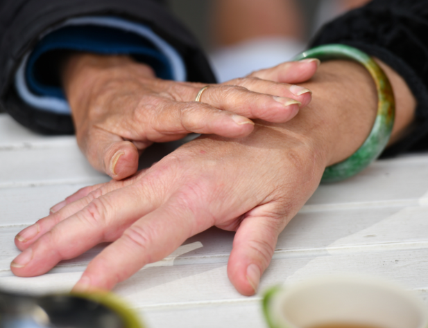 Close-up photo of two hands, one is reaching out to touch the other.