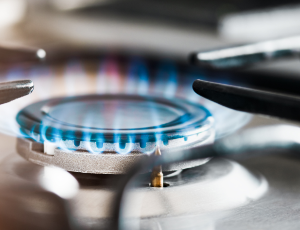 Close-up photo of gas stove with blue flame