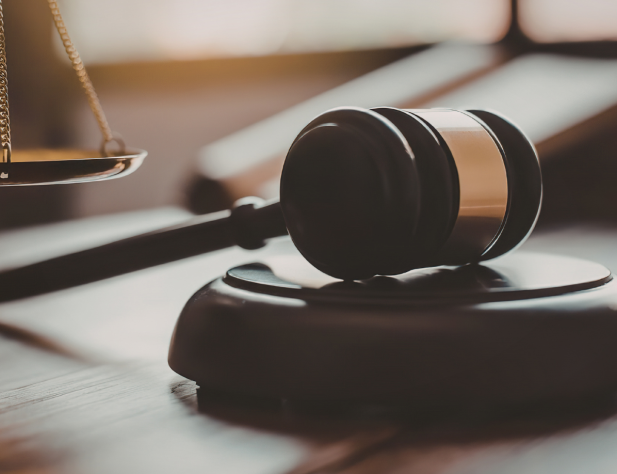 Close-up photo of a gavel sitting on a desk