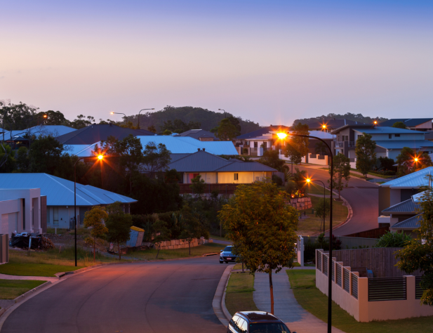 Photo of Australian neighbourhood at dusk; illuminated by purple blue light and street lights