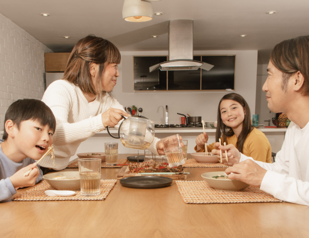 Family sitting at a table eating.